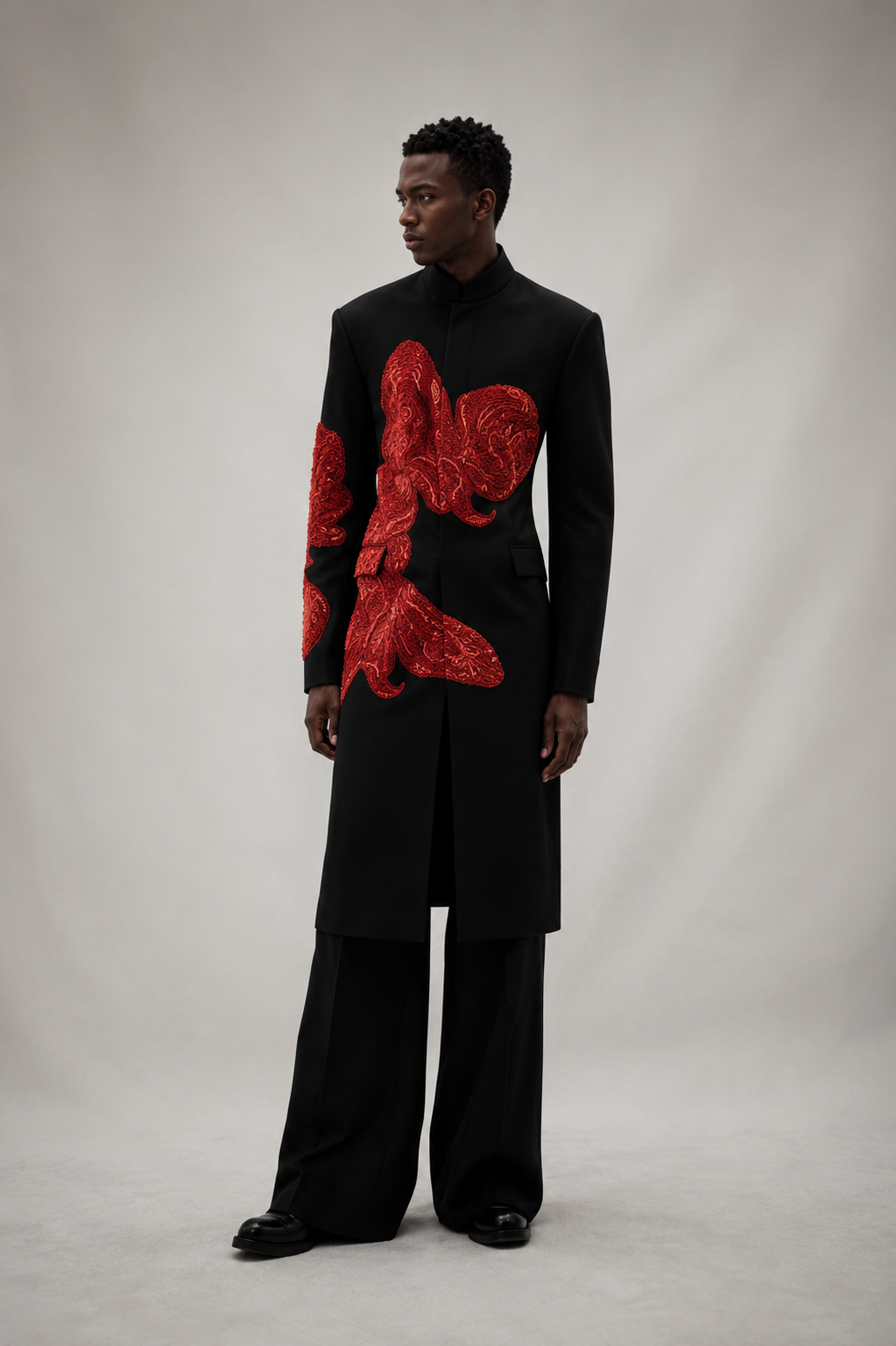 Black contemporary formal outfit with bold red floral embroidery.