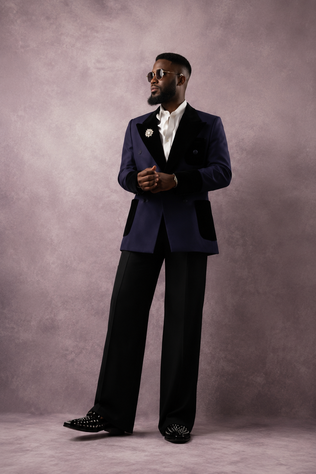 Man wearing a tailored navy blue formal suit.